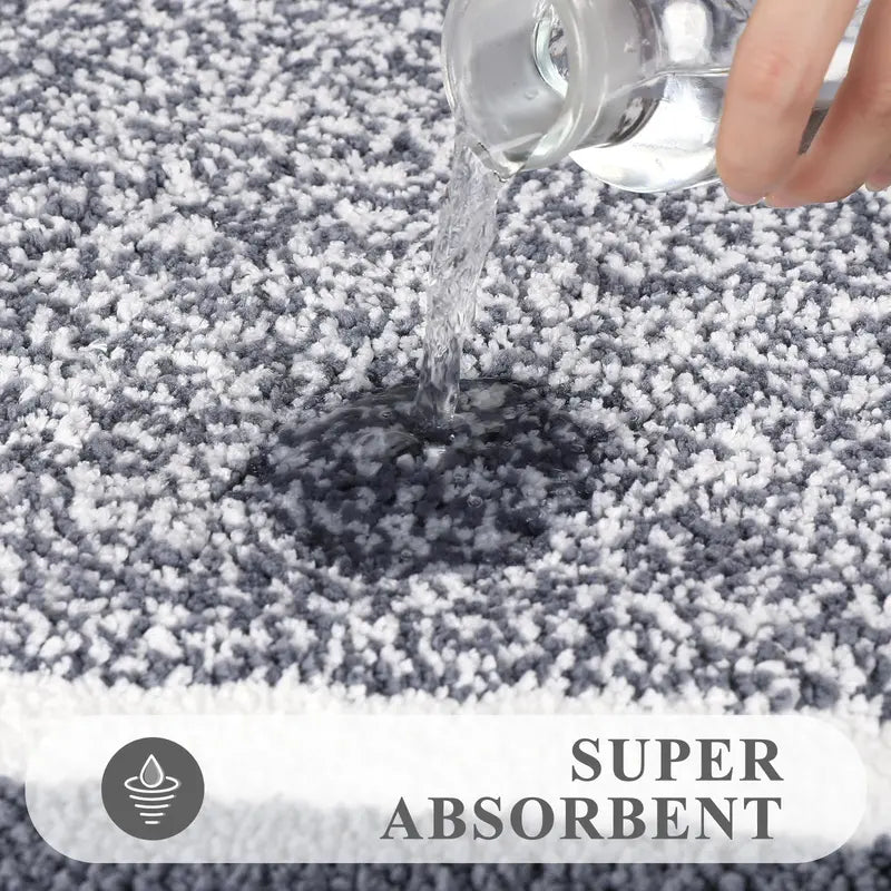 Absorbent plush bathroom rug surface